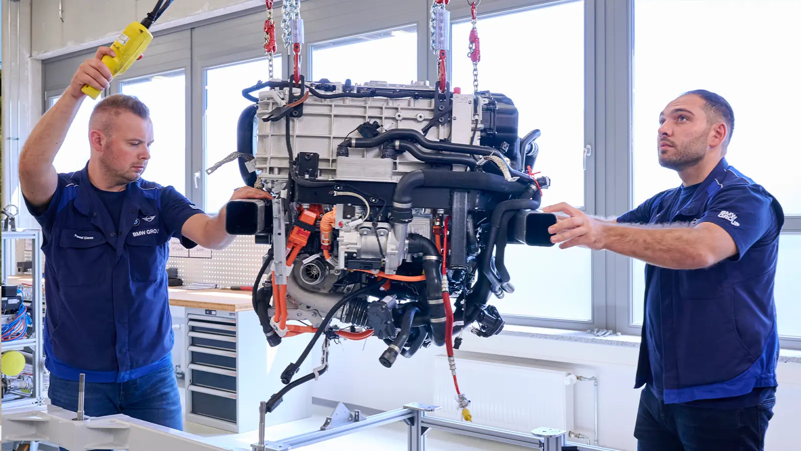 BMW mechanics look at engine